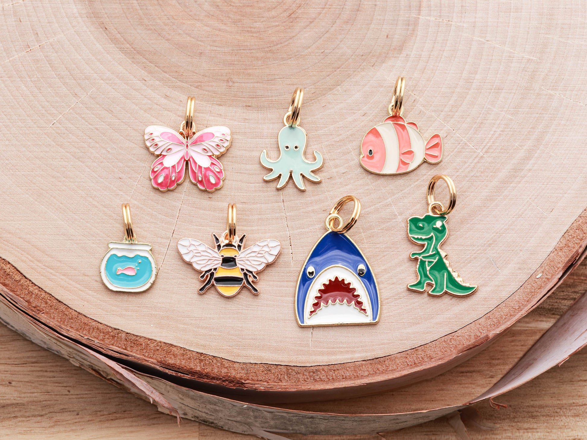 Lucky Tags Collar Charms are available in Bees, Butterflies, Dinosaurs, Fish, Fish Bowls, Octopus, and Sharks
